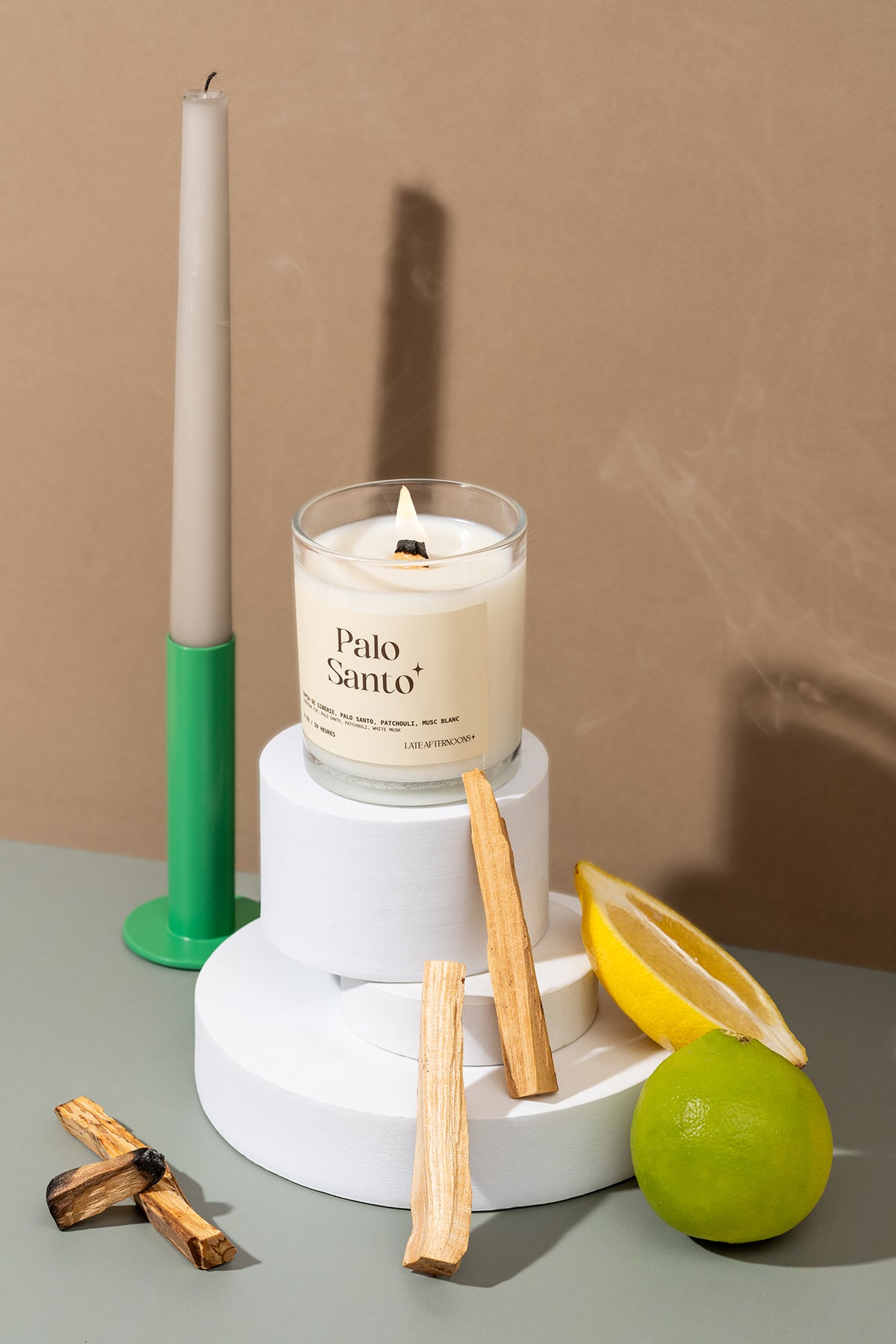 Lit Palo Santo candle styled with palo santo wood and citrus by Late Afternoons