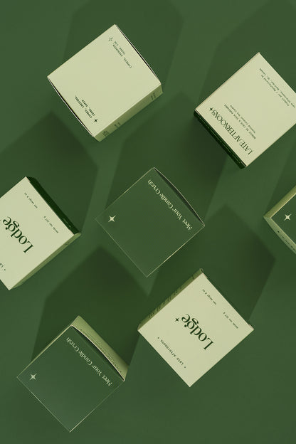 Lodge candle packaging boxes styled on a green background by Late Afternoons
