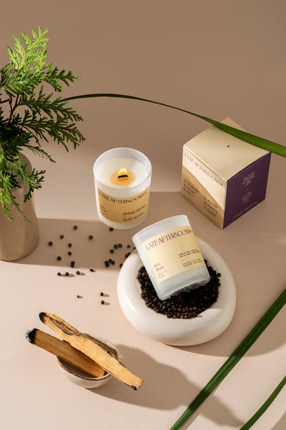 Bois Blanc candle lit with a cedar branch, black peppercorns and palo santo sticks